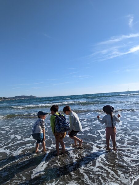 a group of kids standing on a beach